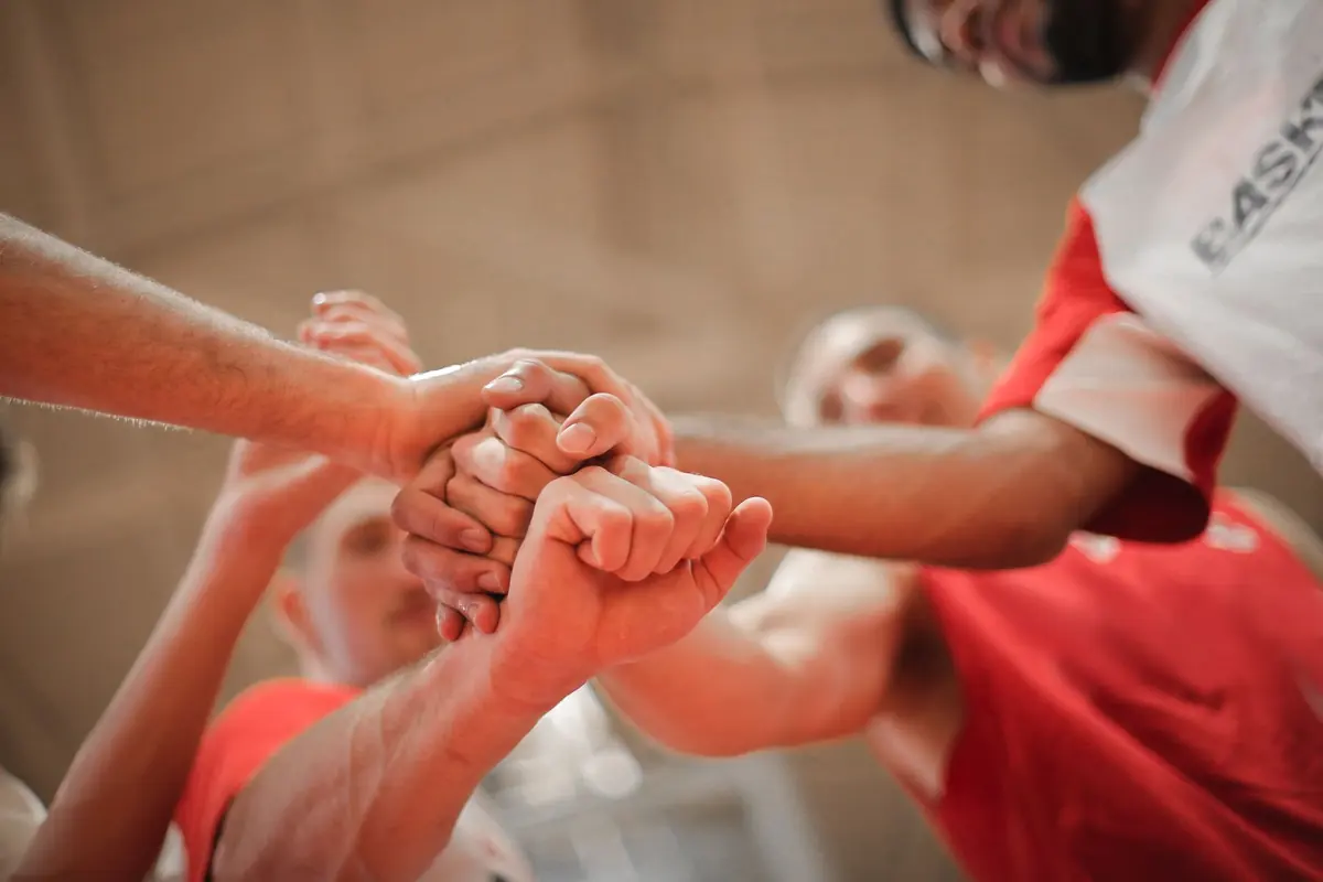 A team's players stack their hands together
